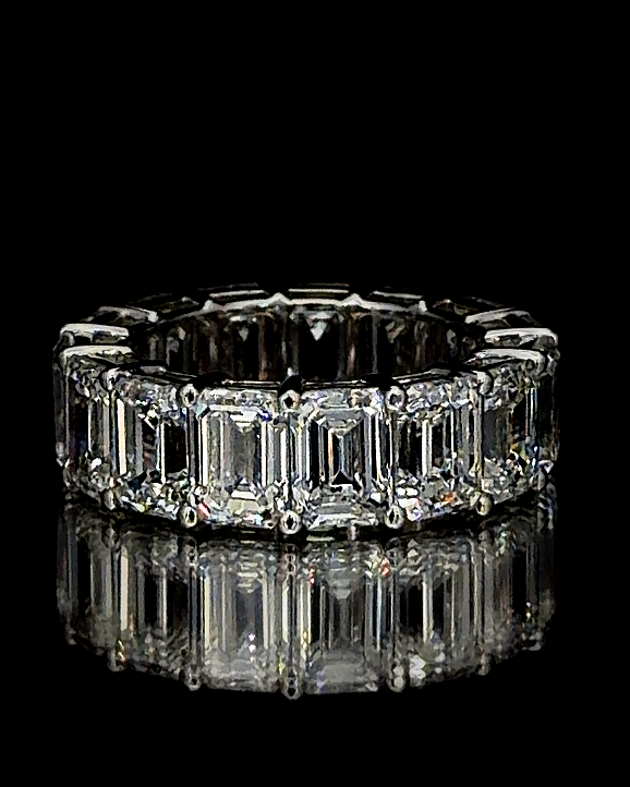 Main: White gold emerald-cut eternity ring with 15 lab grown diamonds on black
Detail: Close-up of prong-set emerald-cut lab grown diamonds in a white gold eternity ring
Side: White gold full eternity band encircled by emerald-cut lab grown diamonds
