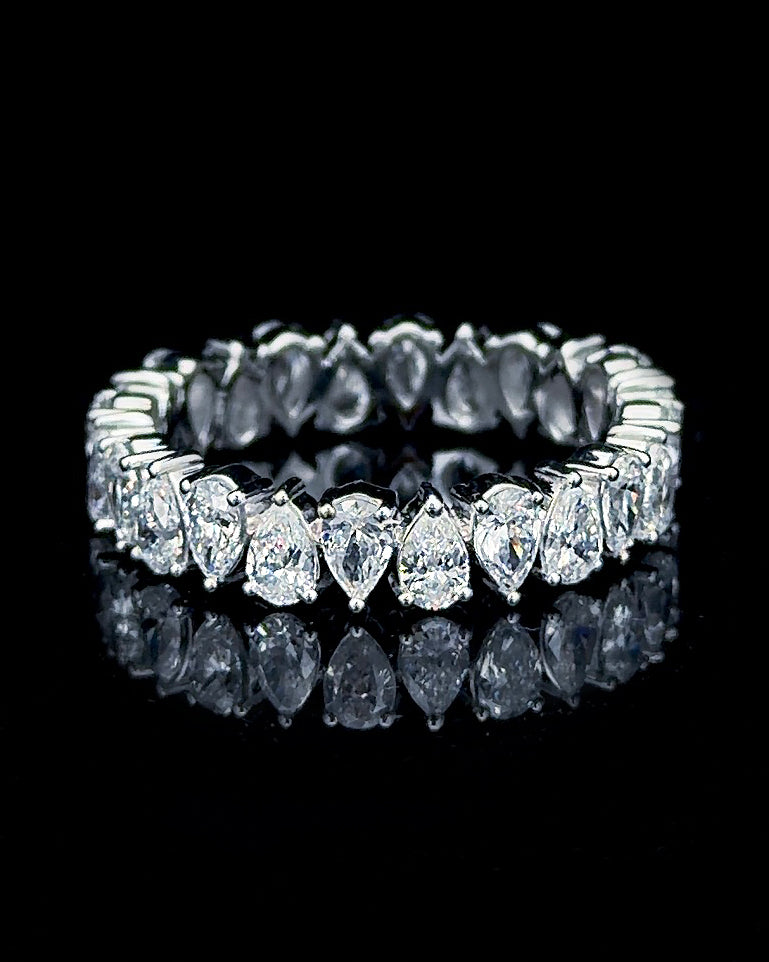 Main: White gold full eternity ring with 20 pear-cut lab grown diamonds on black
Detail: Close-up of pear-cut lab grown diamonds individually prong set around a white gold eternity ring
Side: White gold full eternity band showing continuous pear-shaped lab grown diamonds around the ring
