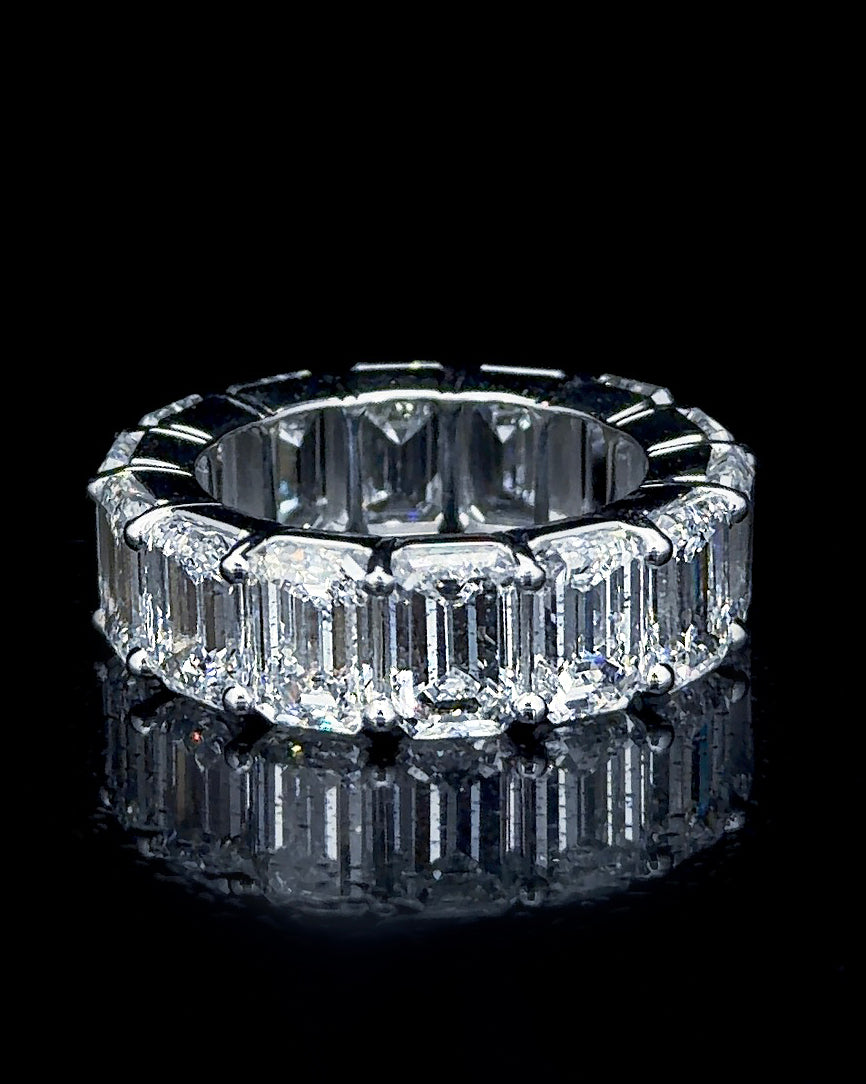 Main: White gold statement eternity ring set with 15 emerald-cut lab grown diamonds against black
Detail: Close-up of rectangular emerald-cut lab grown diamonds secured in white gold prongs
Side: Angled view of white gold eternity ring with emerald-cut lab grown diamonds circling the finger