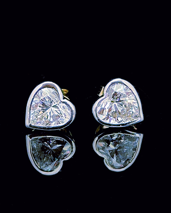White gold heart bezel stud earrings with 1.50ct total lab grown diamonds on black