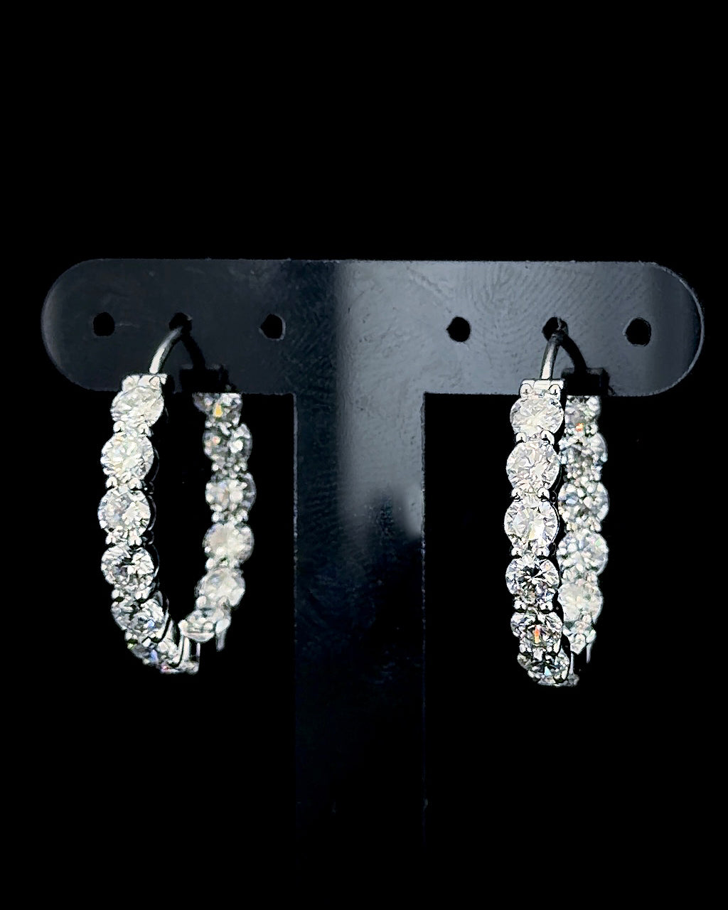 White gold hoop earrings with 4.16ct round lab grown diamonds photographed on black