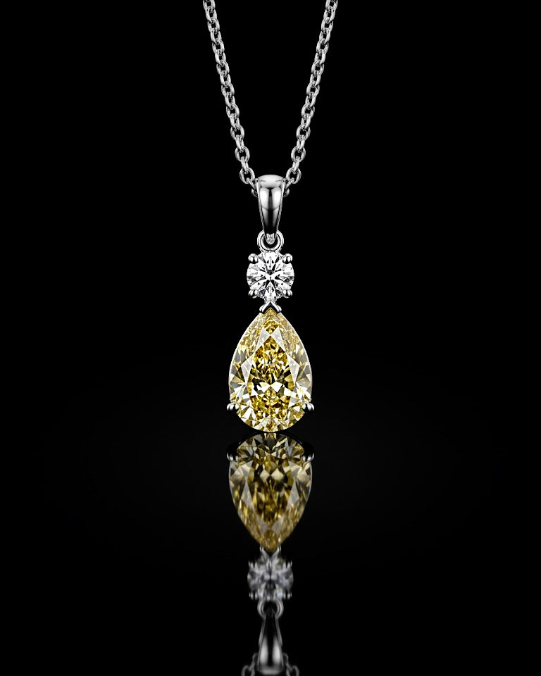 Main: White gold 3.00ct yellow pear pendant with round lab grown diamond accent on black
Detail: Close-up of yellow pear lab grown diamond suspended beneath a round diamond in white gold
Side: White gold pear drop pendant showing prong-set lab grown diamonds and polished bail