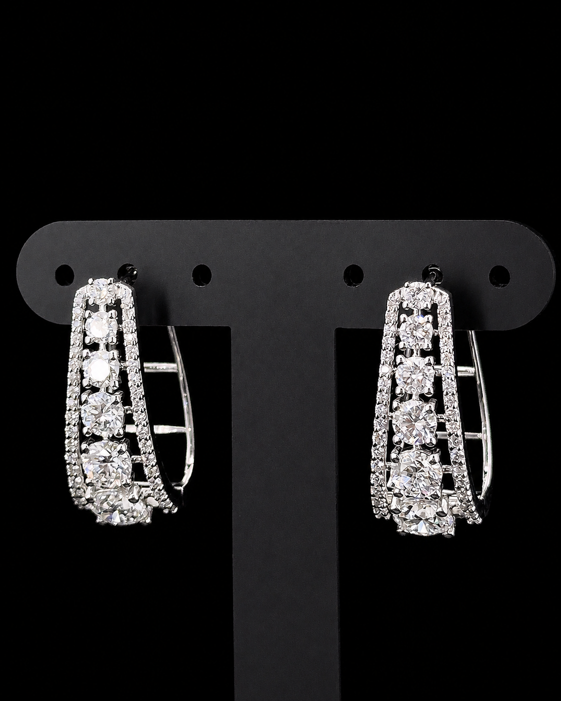 White gold graduated hoop earrings with 3.206ct round lab grown diamonds on black