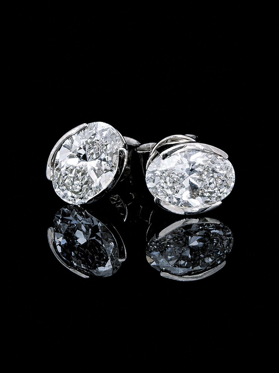White gold oval solitaire stud earrings with 3.50ct total lab grown diamonds on black