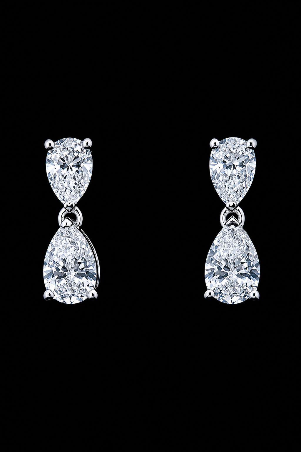 White gold pear drop earrings with four lab grown diamonds on black