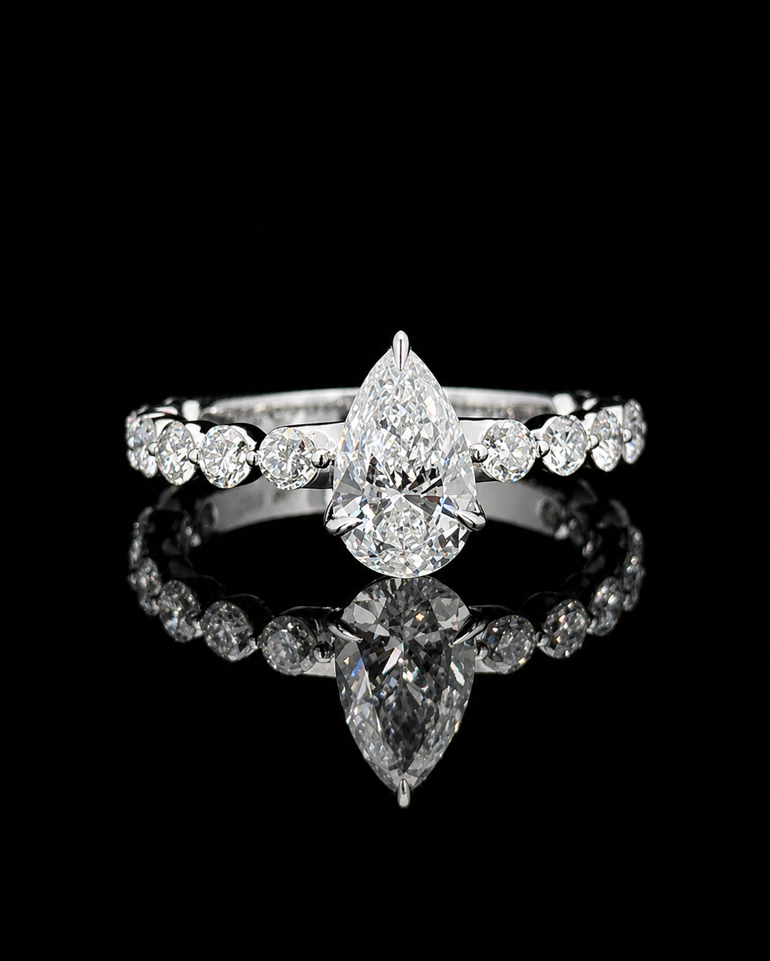 White gold 1.01ct pear ring with round lab grown diamond shoulder stones on black