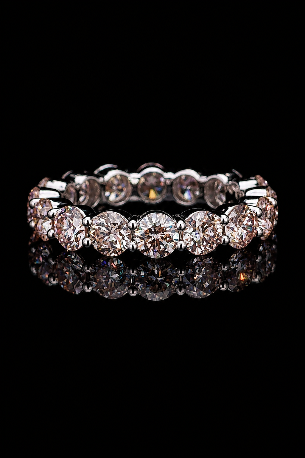 The Eternally round lab-grown diamond full-eternity ring in white gold on a black reflective background