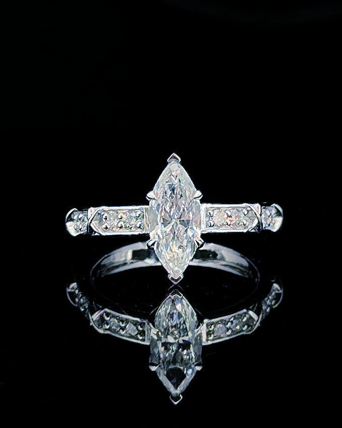 Main: White gold 1.00ct marquise ring with pave lab grown diamond shoulders on black
Detail: Close-up of 1.00ct marquise lab grown diamond in a sculptural white gold prong setting
Side: White gold marquise ring with crossover details and round lab grown diamond pave shoulders