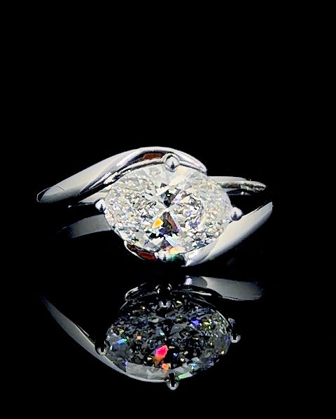 Main: White gold 1.67ct oval bypass solitaire ring with lab grown diamond centre on black
Detail: Close-up of 1.67ct oval lab grown diamond held in a four-prong white gold setting
Side: White gold oval solitaire ring with sculptural bypass shoulders and raised diamond setting