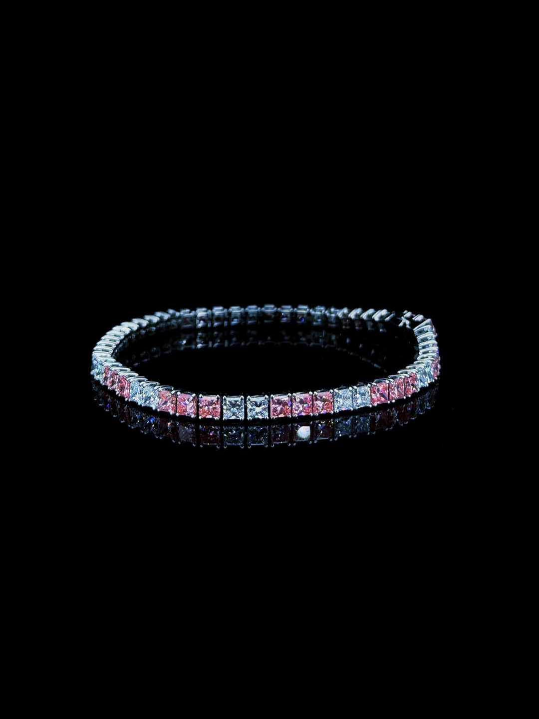 White gold tennis bracelet with pink and white princess cut lab grown diamonds on black