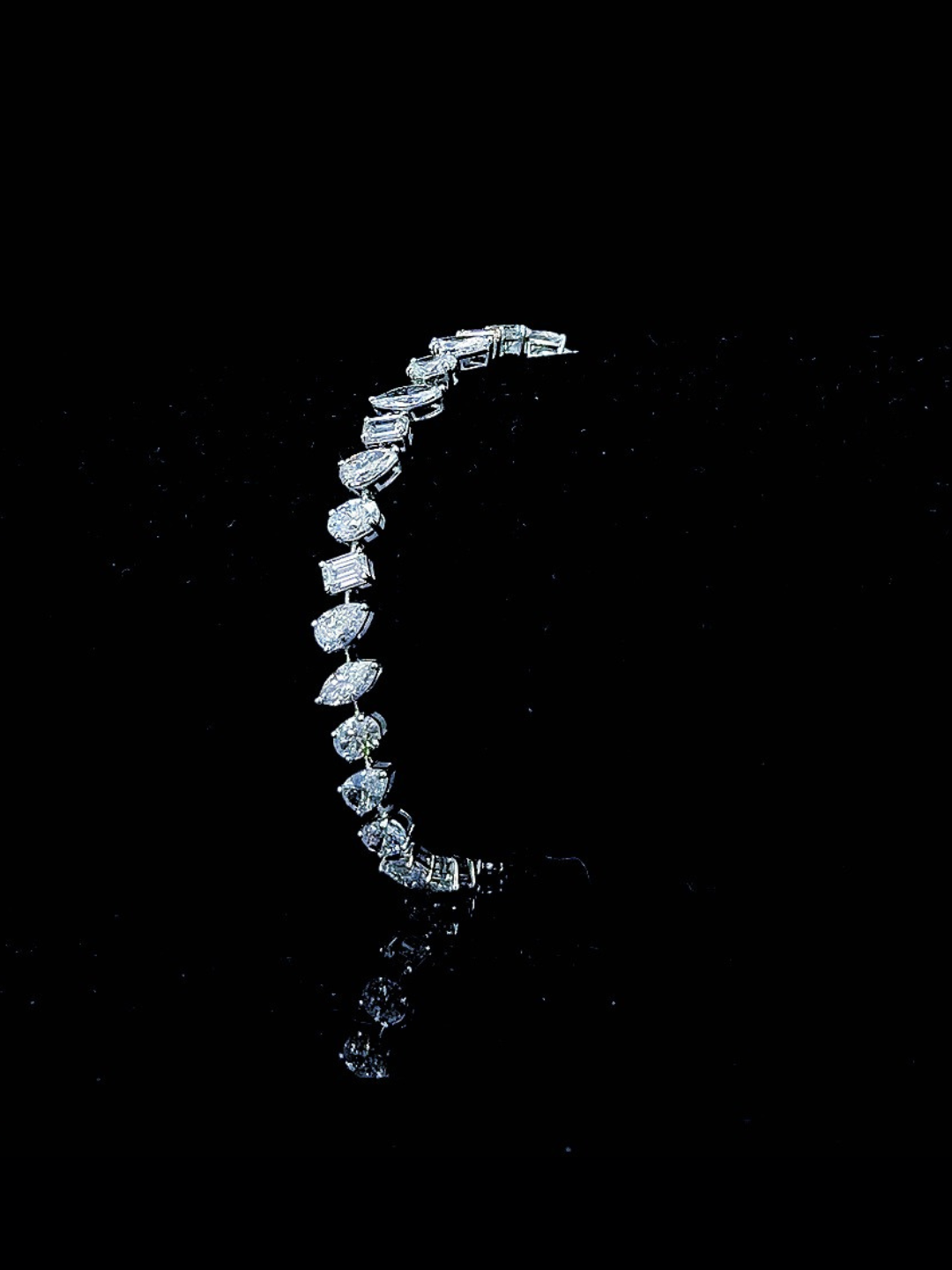 White gold mixed-shape tennis bracelet with 6.83ct lab grown diamonds photographed on black
