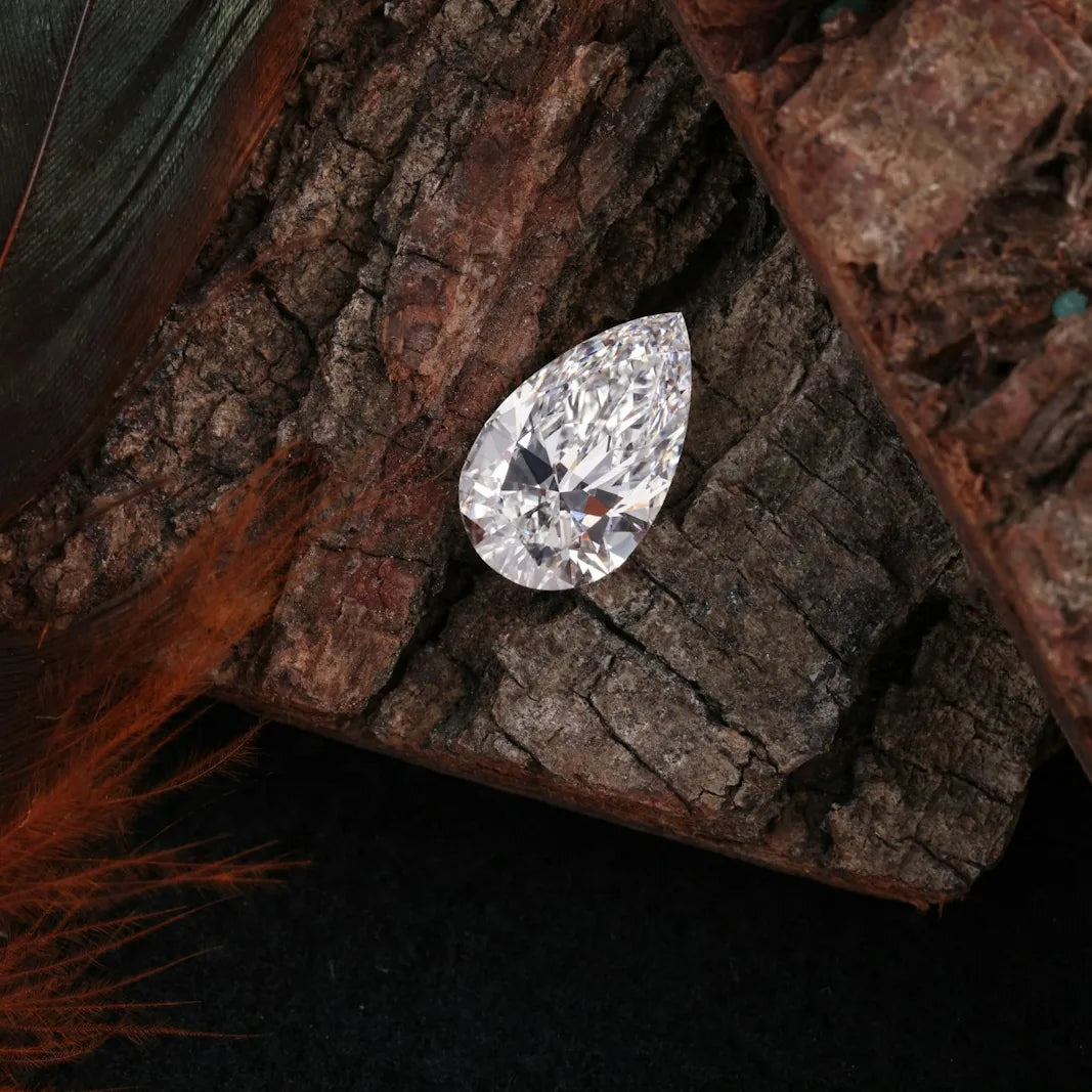 Pear shaped diamond resting on wood