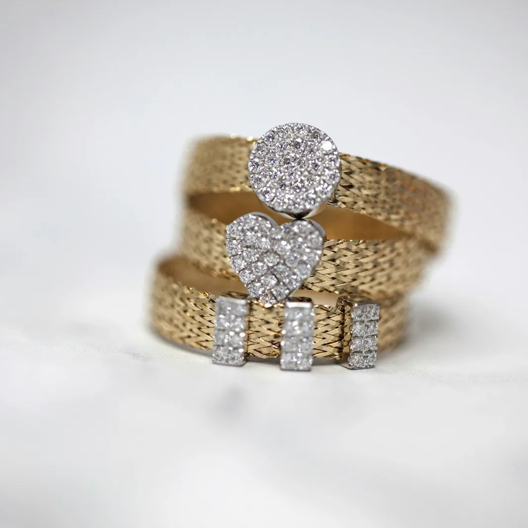 Three gold diamond set rings arranged together
