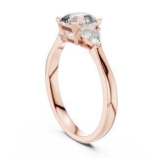 emerald diamond three stone engagement ring in rose gold