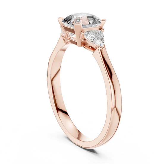 emerald diamond three stone engagement ring in rose gold