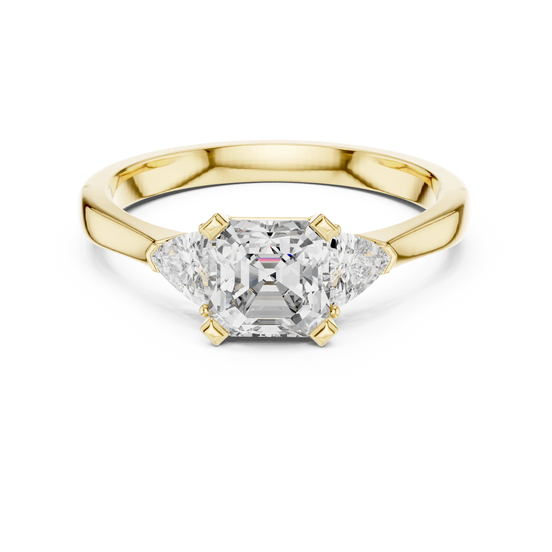 emerald diamond three stone engagement ring in yellow gold