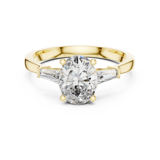 oval diamond tapered baguette ring in yellow gold
