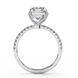 Side profile of a radiant cut lab grown diamond engagement ring with a hidden halo and pavé band in white gold