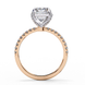 Side profile of a radiant cut lab grown diamond engagement ring with a hidden halo and pavé band in rose gold