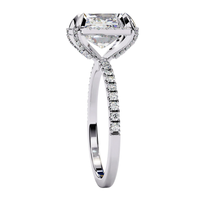 Radiant cut diamond engagement ring in white gold from a side angle.