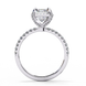 Side profile view of a white gold radiant cut lab grown diamond engagement ring with a pavé band.
