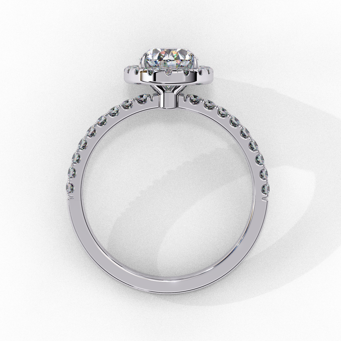 Side profile of a white gold oval cut diamond engagement ring showing the low-profile basket construction.