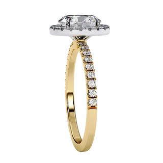 Oval diamond halo engagement ring in yellow gold from side angle.