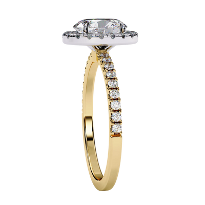 Oval diamond halo engagement ring in yellow gold from side angle.