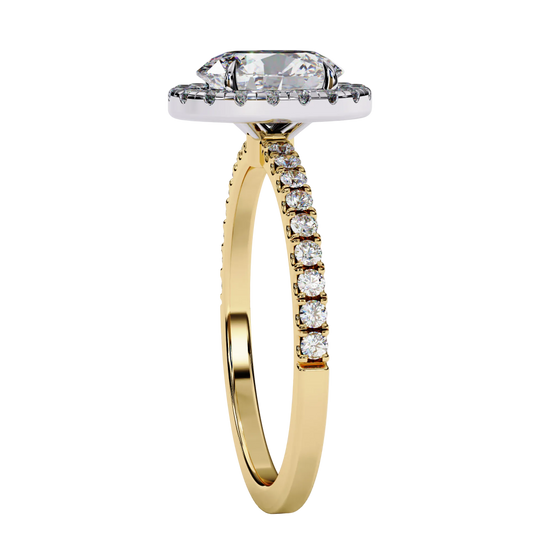 Oval diamond halo engagement ring in yellow gold from side angle.