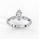 Side profile view of a white gold marquise cut diamond ring highlighting the unique bezel-set accents along the band.