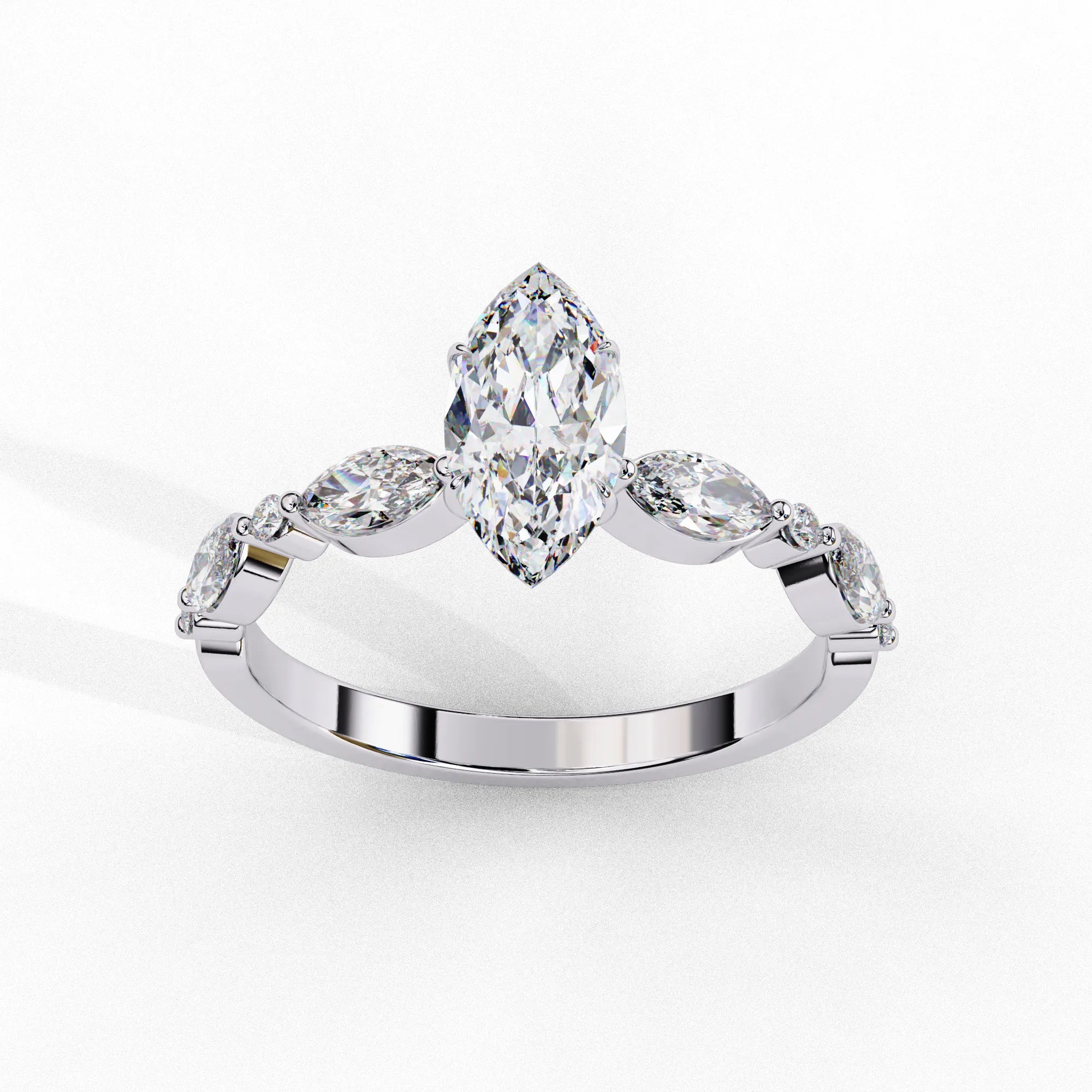 Side profile view of a white gold marquise cut diamond ring highlighting the unique bezel-set accents along the band.