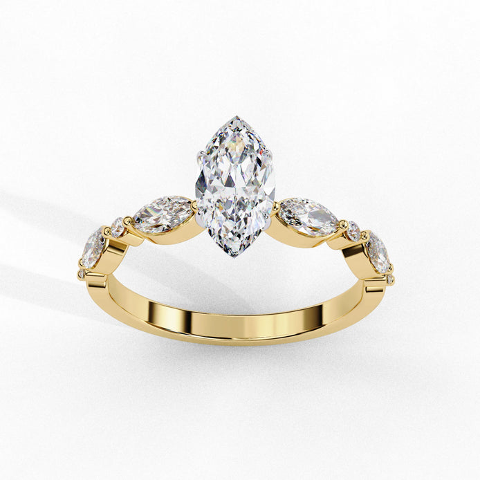 Side profile view of a yellow gold marquise cut diamond ring highlighting the unique bezel-set accents along the band.