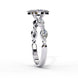 Side profile view of a white gold marquise cut diamond engagement ring showcasing an elegant cathedral gallery profile.