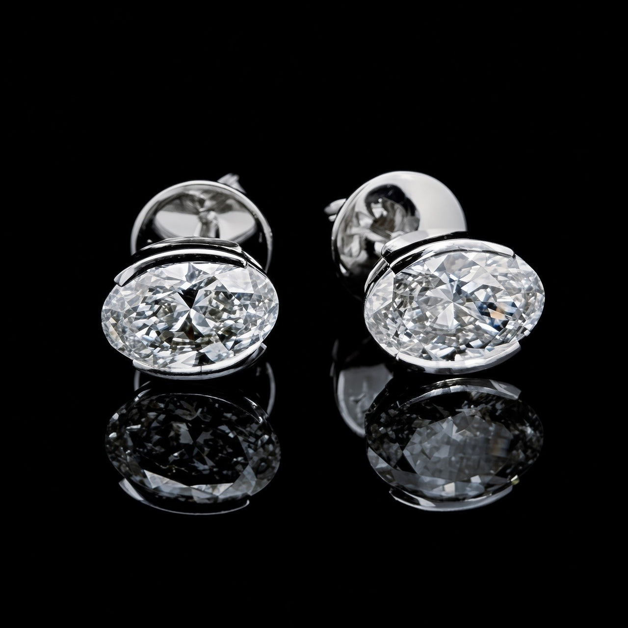 White gold oval solitaire stud earrings with 3.50ct total lab grown diamonds on black