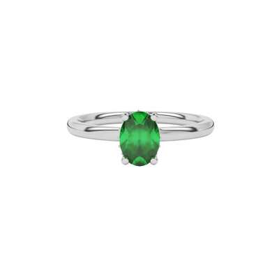 Close-up oval cut emerald green gemstone ring, white gold pavé basket.
