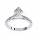 Diamond ring with a pear-shaped center stone on a white background