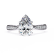 Diamond ring with a pear-shaped center stone on a white background