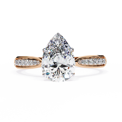 Rose gold ring with a large pear-shaped diamond and smaller diamonds on the band against a white background
