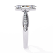Diamond ring with a central stone and smaller stones on the band against a white background
