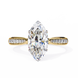 Gold ring with a large marquise-shaped diamond and smaller diamonds on the sides against a white background