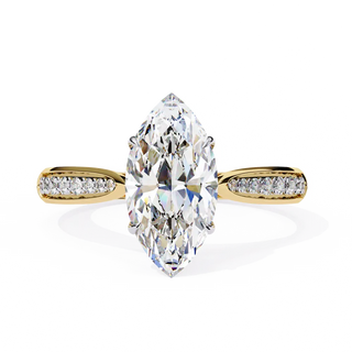 Gold ring with a large marquise-shaped diamond and smaller diamonds on the sides against a white background