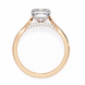 Rose gold ring with a large diamond and smaller diamonds on the band against a white background
