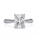 Diamond ring with a rectangular center stone on a white background