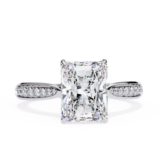 Diamond ring with a rectangular center stone on a white background