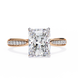 Gold ring with a large diamond and smaller diamonds on the band against a white background