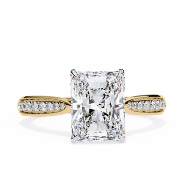 Gold ring with a large diamond and smaller diamonds on the band against a white background