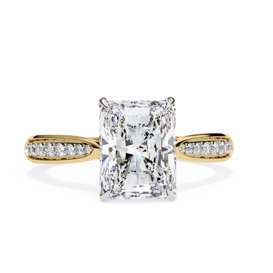 Gold ring with a large diamond and smaller diamonds on the band against a white background