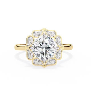 Gold ring with a large diamond and smaller diamonds on the band against a white background