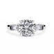 Diamond ring with a large central gemstone and smaller stones on the sides on a white background