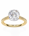 Gold ring with a large diamond and smaller diamonds on the band against a white background